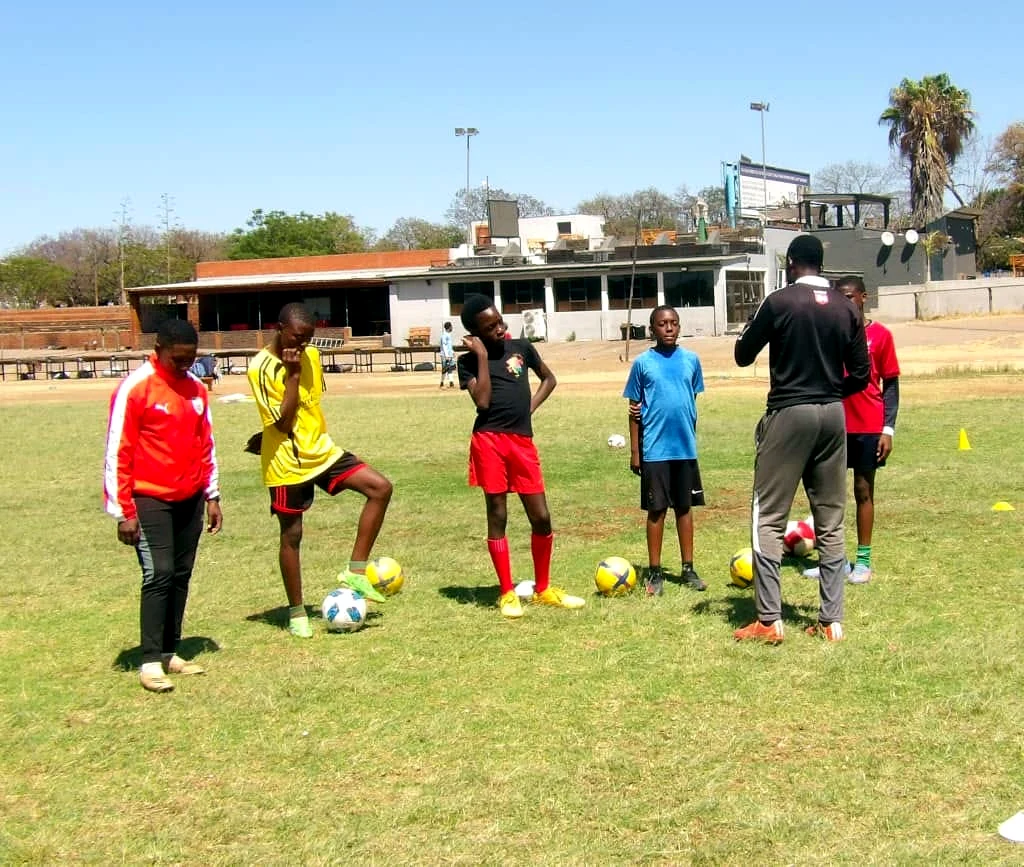 Players and coach in a ball mastery training session