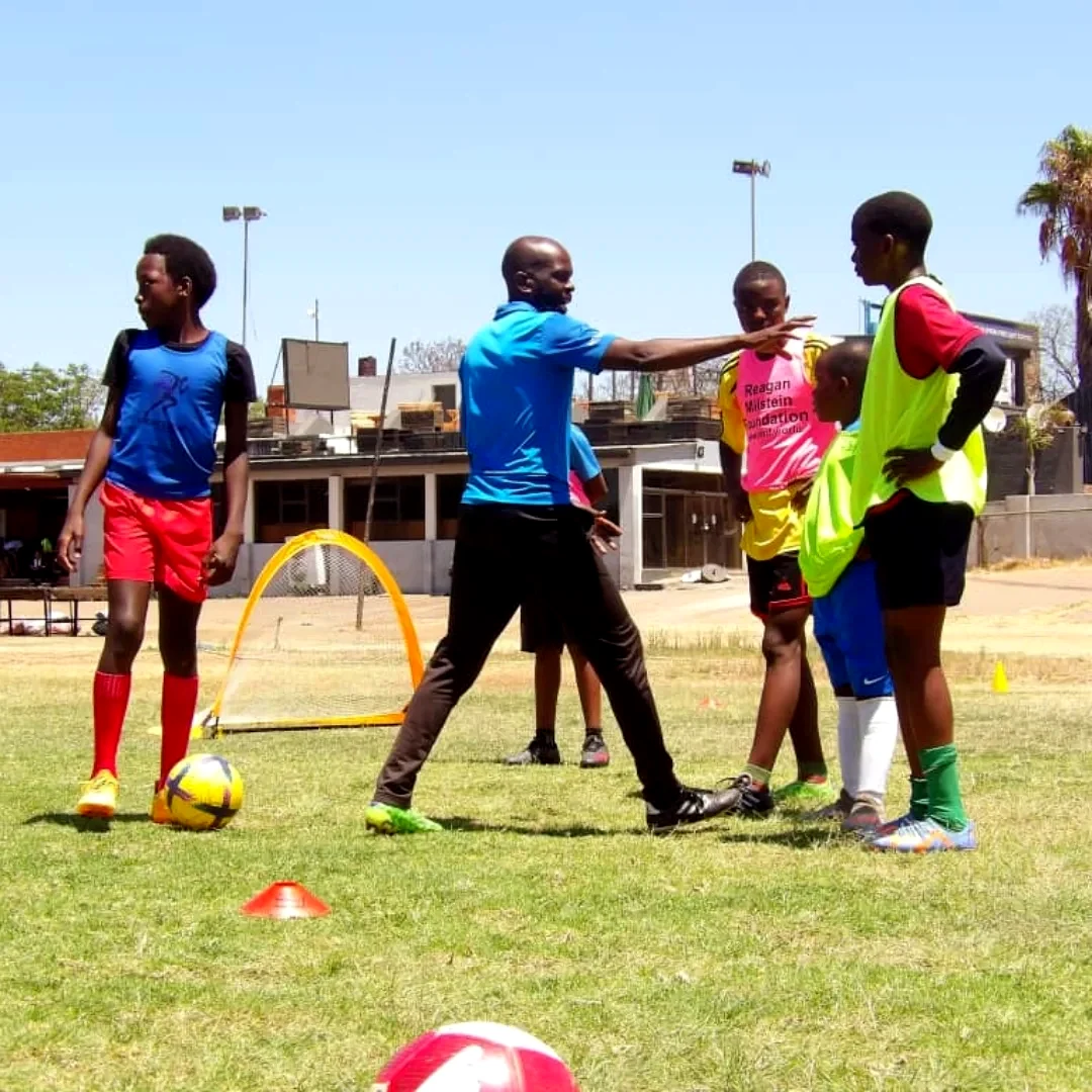 Coach providing instructions to players on the field