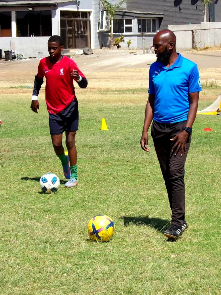 Coach observing player development during training