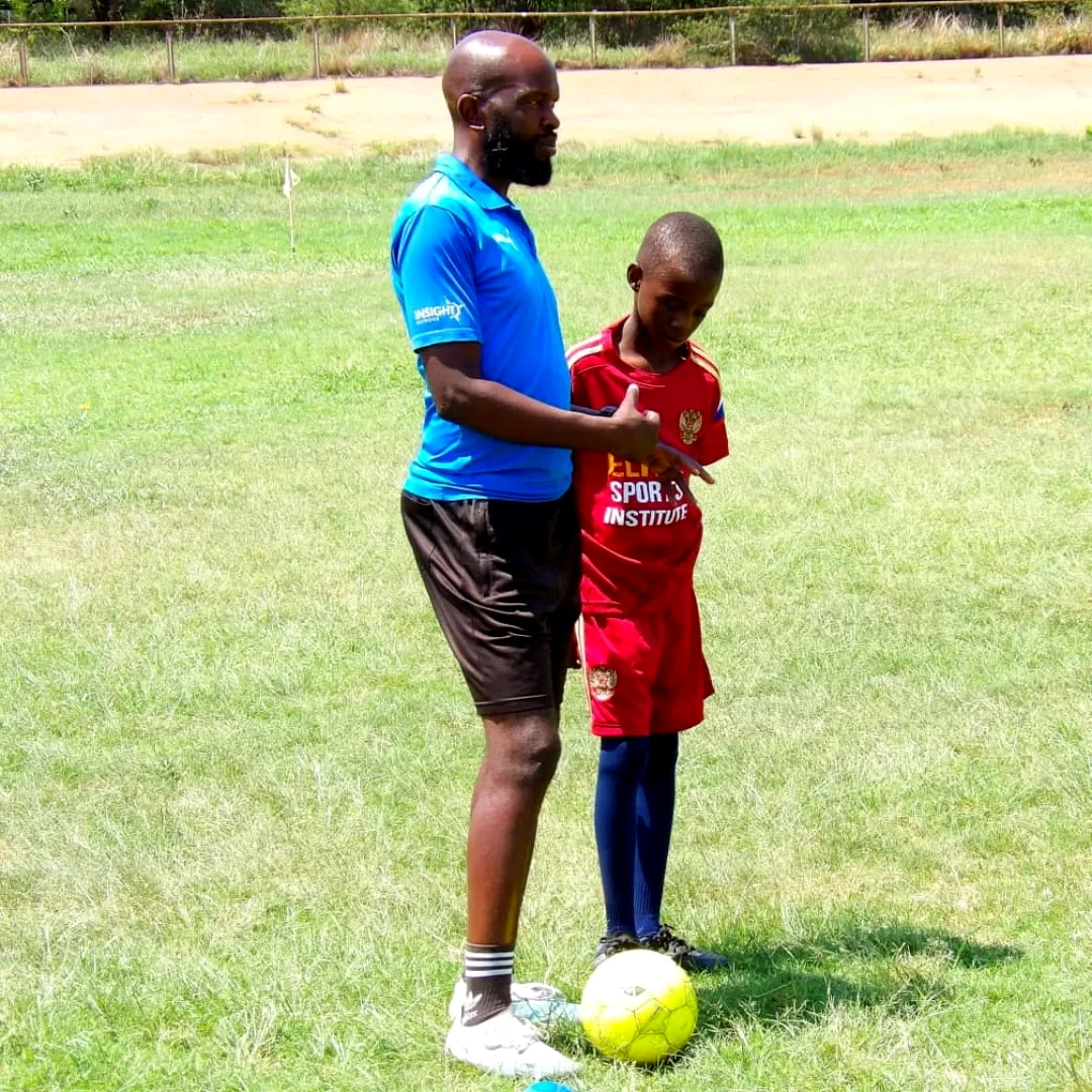 Coach Admire Nyathi guiding a player one to one